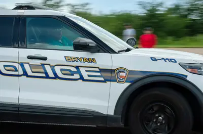 closeup of a Bryan Police vehicle in motion