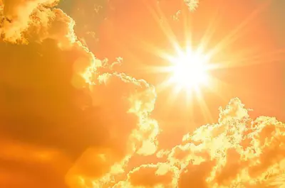 scorching sun shining in a fiery sky