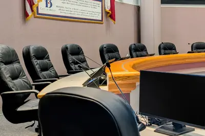 view of city council and city secretary seating desks in council chambers