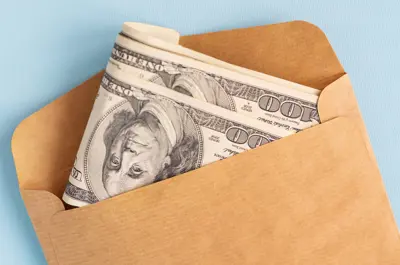 envelope with hundred dollar bills peeking out