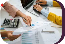 hands holding and documenting financial paperwork using a calculator