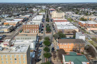 Aerial of a busy Historic Downtown Bryan on a partly cloudy day.