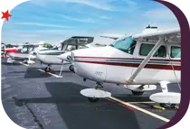 line of personal aircrafts parked on a runway