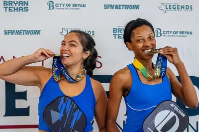 Two 2025 Games of Texas pickleball medalists showing off their awards.