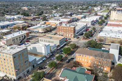 Aerial view of Historic Downtown Bryan on a sunny day, with the Queen Theatre area in the foreground.