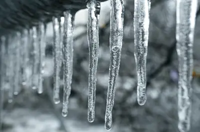 icicles frozen from a roofline during extreme freeze