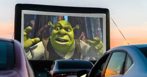outdoor drive-up theater screen with Shrek projection