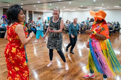 Women dancing, smiling and having fun at a Senior Dance.
