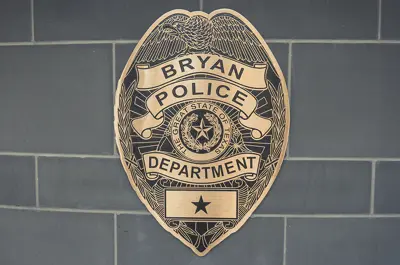 police department placard depicting a badge motif.