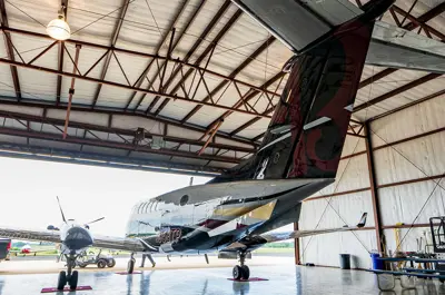 view of an aircraft from inside a large hangar