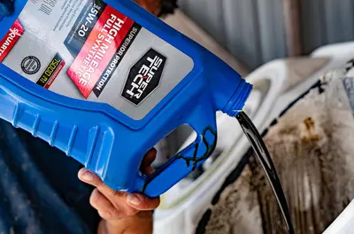 used oil being poured into a receptacle for recycling