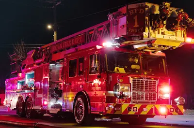 fire truck driving with all lights on at night