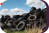 pile of used tires dumped in a field