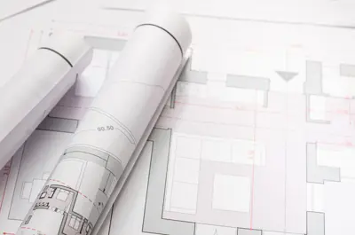 development blueprint paperwork stacked on a table