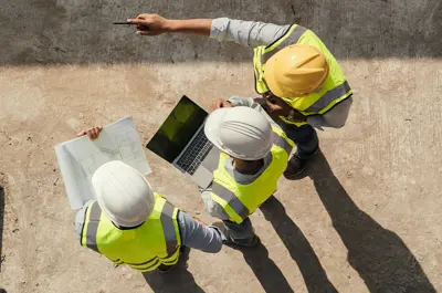 construction crew looking over plans at a construction site