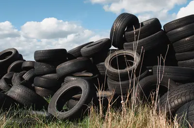 pile of used tires dumped in a field